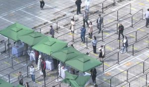 Virus: les Pékinois font la queue pour se faire tester alors que la ville confine des quartiers