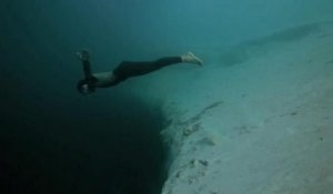 Guillaume Nery base jumping at Deans Blue Hole, filmed on breath hold by Julie Gautier