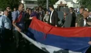 Des Ukrainiens décrochent le drapeau de l'ambassade de Russie à Kiev