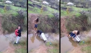 Un jeune homme trop galant aide sa copine à traverser un ruisseau