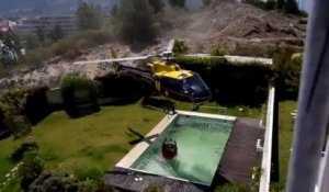 Un Hélicoptère vide une piscine pour éteindre un feu.