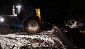 Un tracteur tente de sortir une voiture d'un fossé !