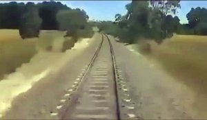 Un motard coincé sur la voie ferrée essaie de sortir ça moto mais il est trop tard