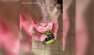 Cette petite fille essaie de jouer avec une "vieille" Game Boy