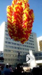 Il s'envole dans le ciel tiré par des ballons gonflés à l'hélium