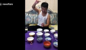 Man plays Chinese tunes on rice bowls with chopsticks