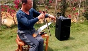 Chinese man uses musical saw to play Japanese ballad