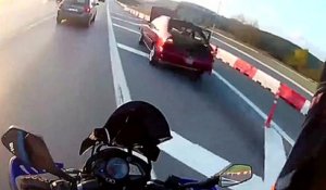 Un motard qui roule sur la bande d'arrêt d'urgence pendant des ralentissements percute une voiture