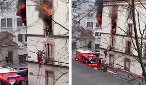 Un pompier sort une femme d'un appartement en feu
