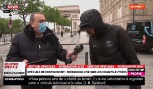Clin d'oeil: En pleine émission de "Morandini Live" en direct sur les Champs-Elysées, un homme en arrière plan chute soudainement